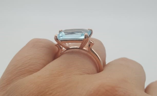 Stunning light blue emerald shape women's ring.